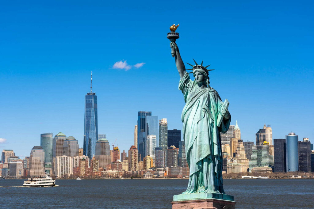 Statua della libertà con una città sullo sfondo Statua della libertà con una città sullo sfondo