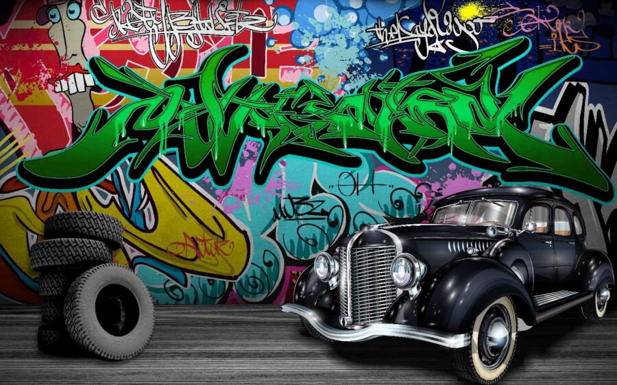 Auto nera con ruote davanti a un muro colorato Auto nera con ruote davanti a un muro colorato