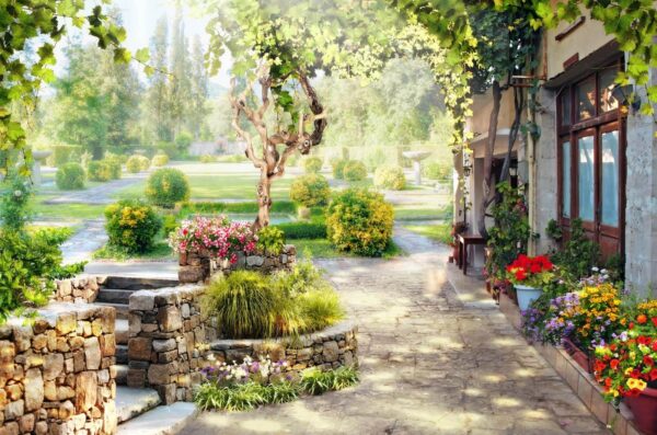 Passerella in pietra con albero e fiori Passerella in pietra con albero e fiori