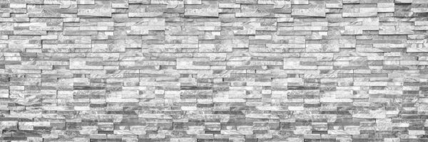 Parete in pietra strutturata con design monocromatico. Parete in pietra strutturata con design monocromatico.