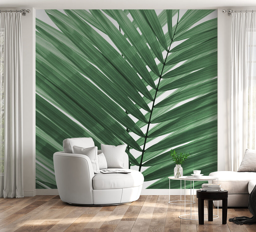 Lush green palm leaves against white