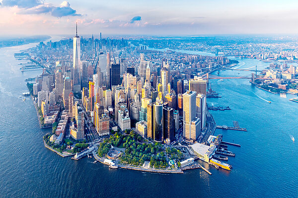 A city with many tall buildings and a body of water