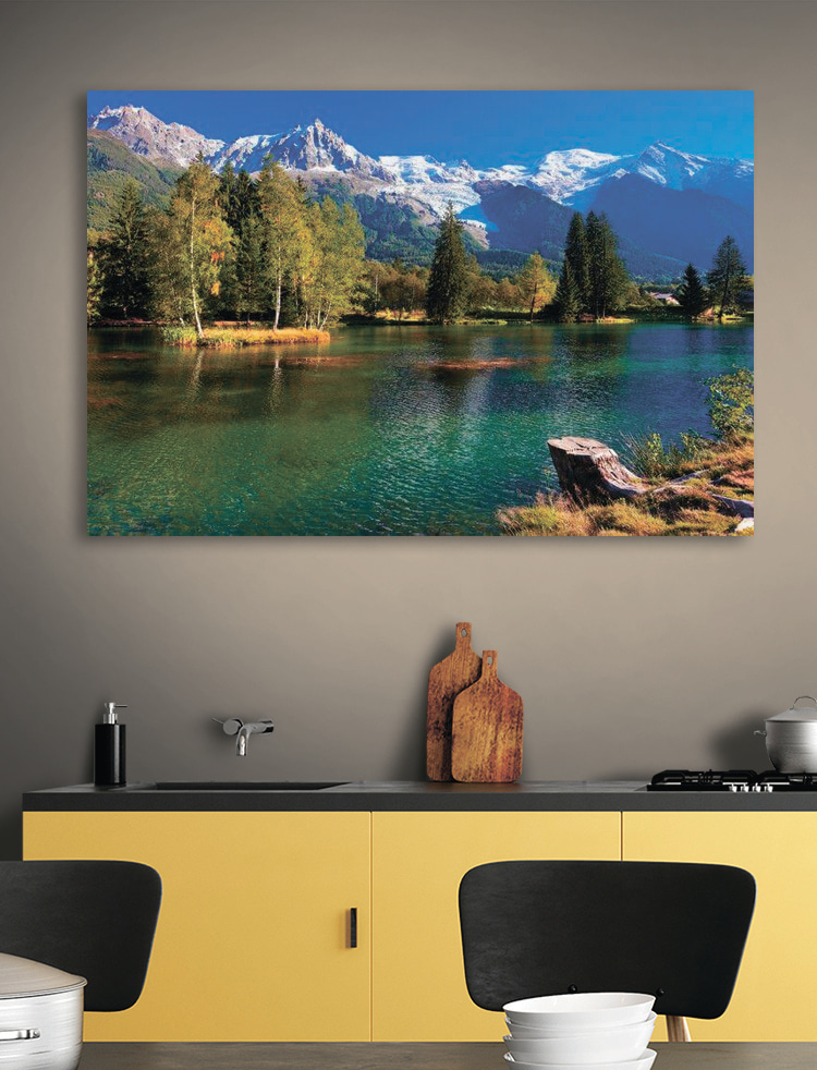 A lake surrounded by trees and mountains A lake surrounded by trees and mountains