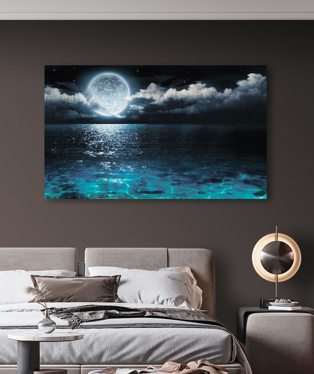 A moon over water at night