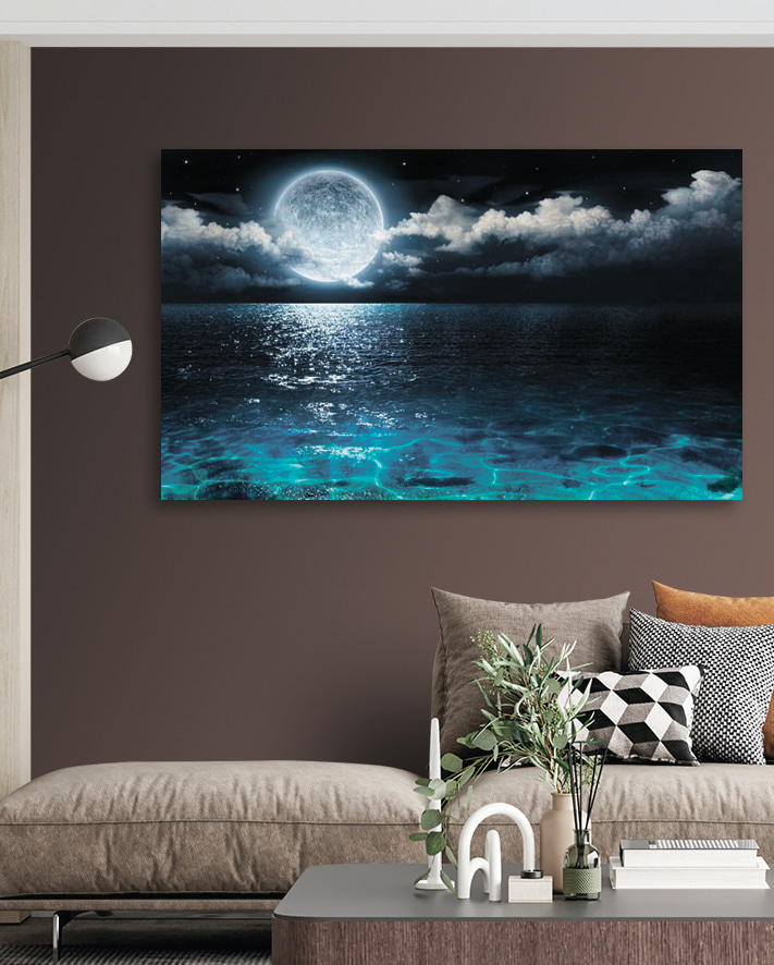 A moon over water at night