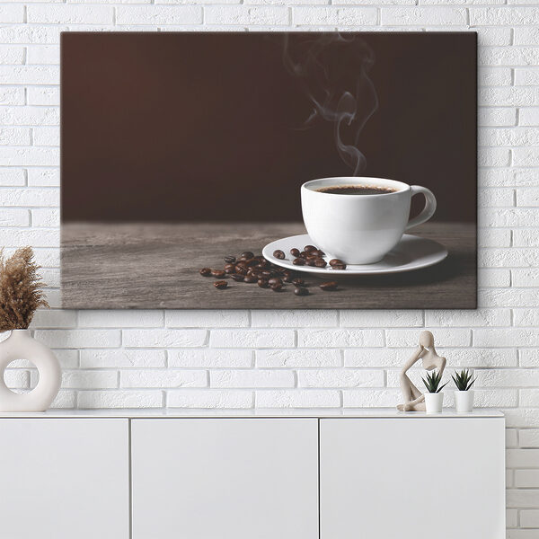 A cup of coffee with smoke and beans on a wooden surface