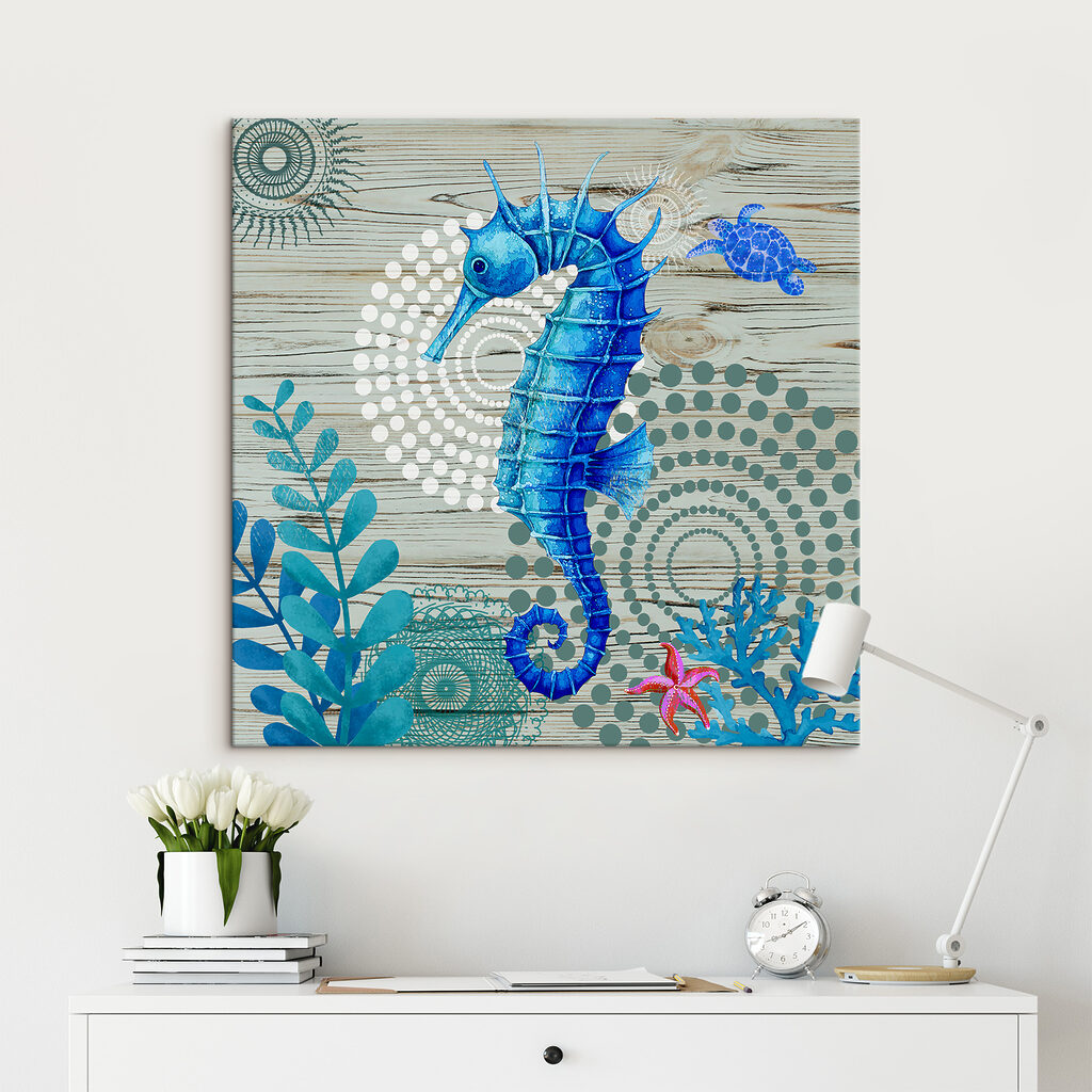 A blue seahorse and seaweed on a wood surface