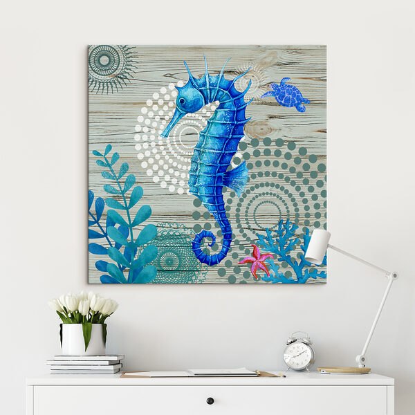 A blue seahorse and seaweed on a wood surface