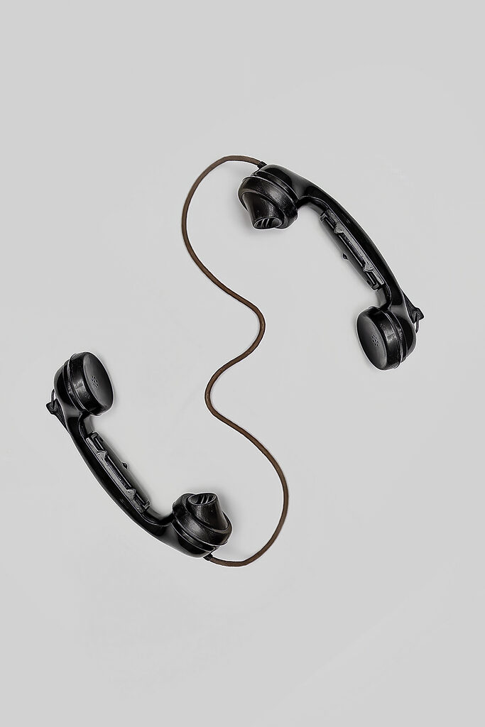 A pair of handsets with a cord A pair of handsets with a cord