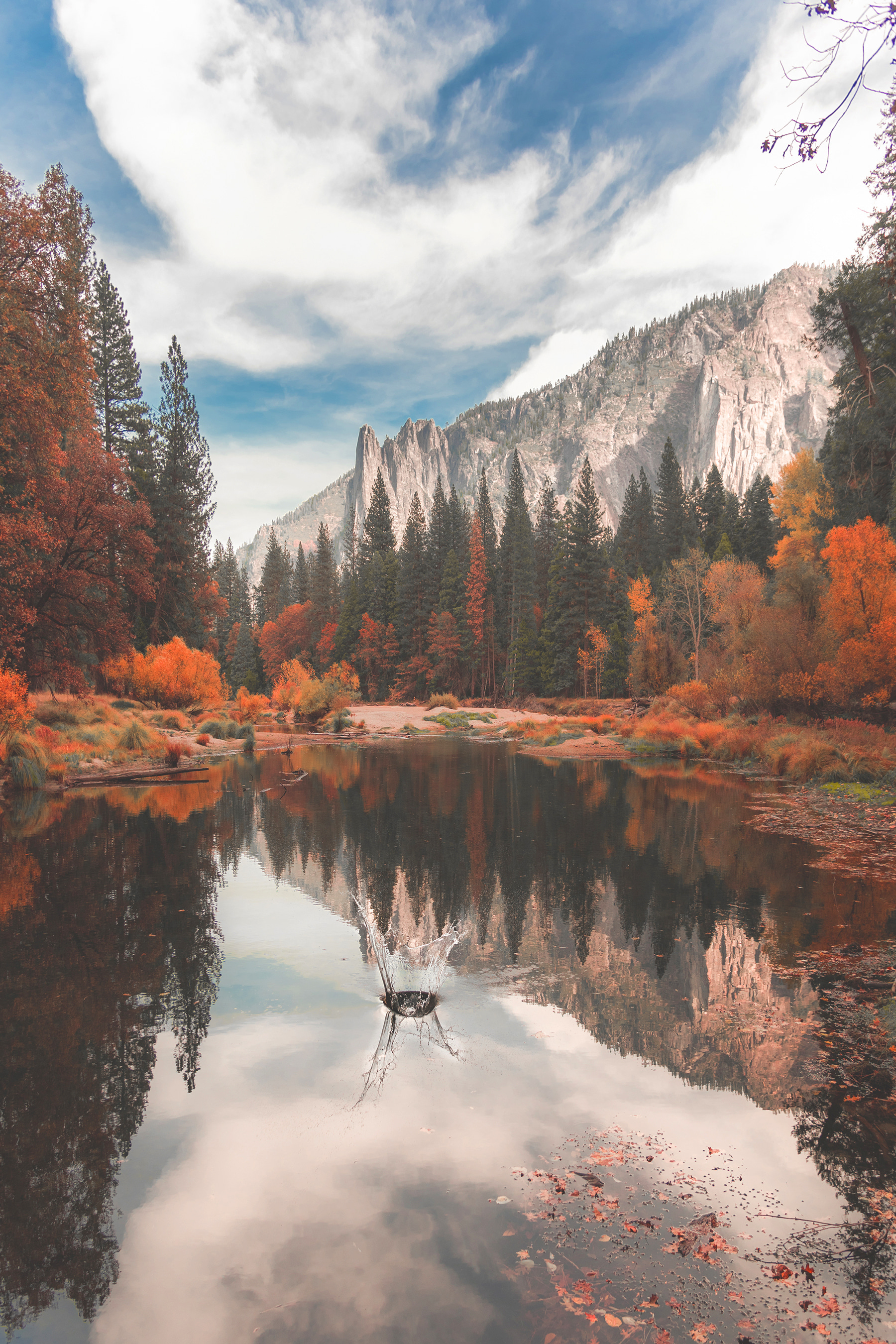 A lake surrounded by trees and mountains A lake surrounded by trees and mountains