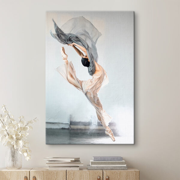 A woman in a dress and pointe shoes jumping in the air