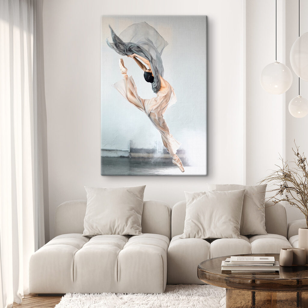 A woman in a dress and pointe shoes jumping in the air
