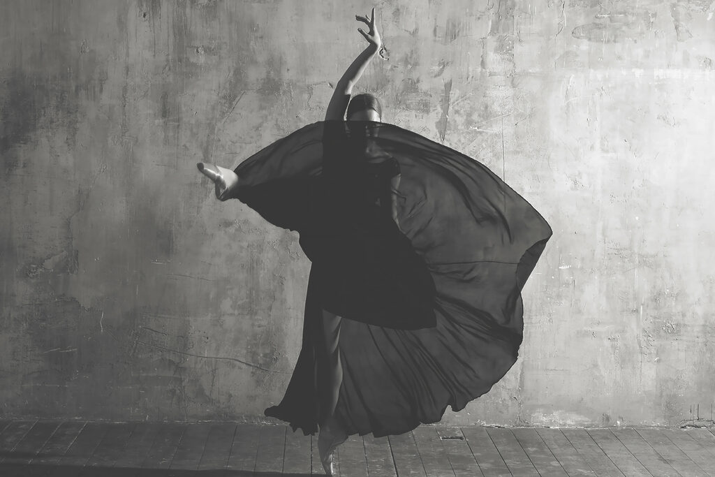 A woman dancing in a black dress A woman dancing in a black dress