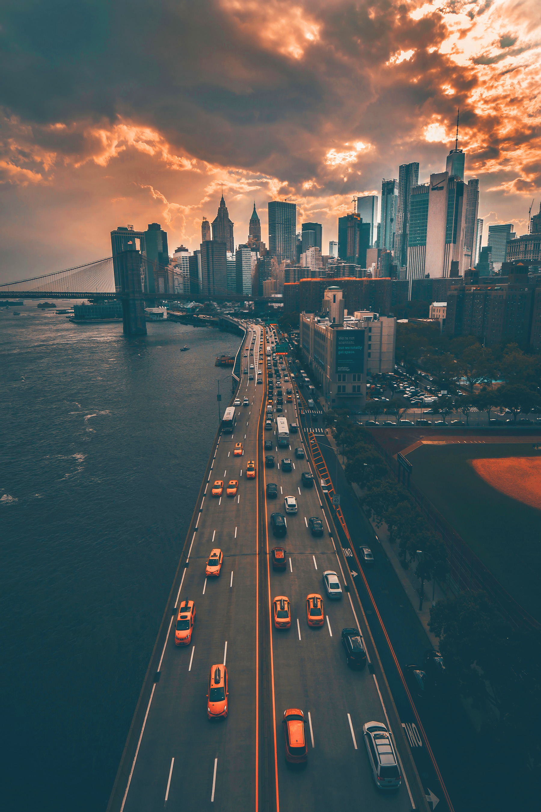 A bridge over water with cars and buildings in the background