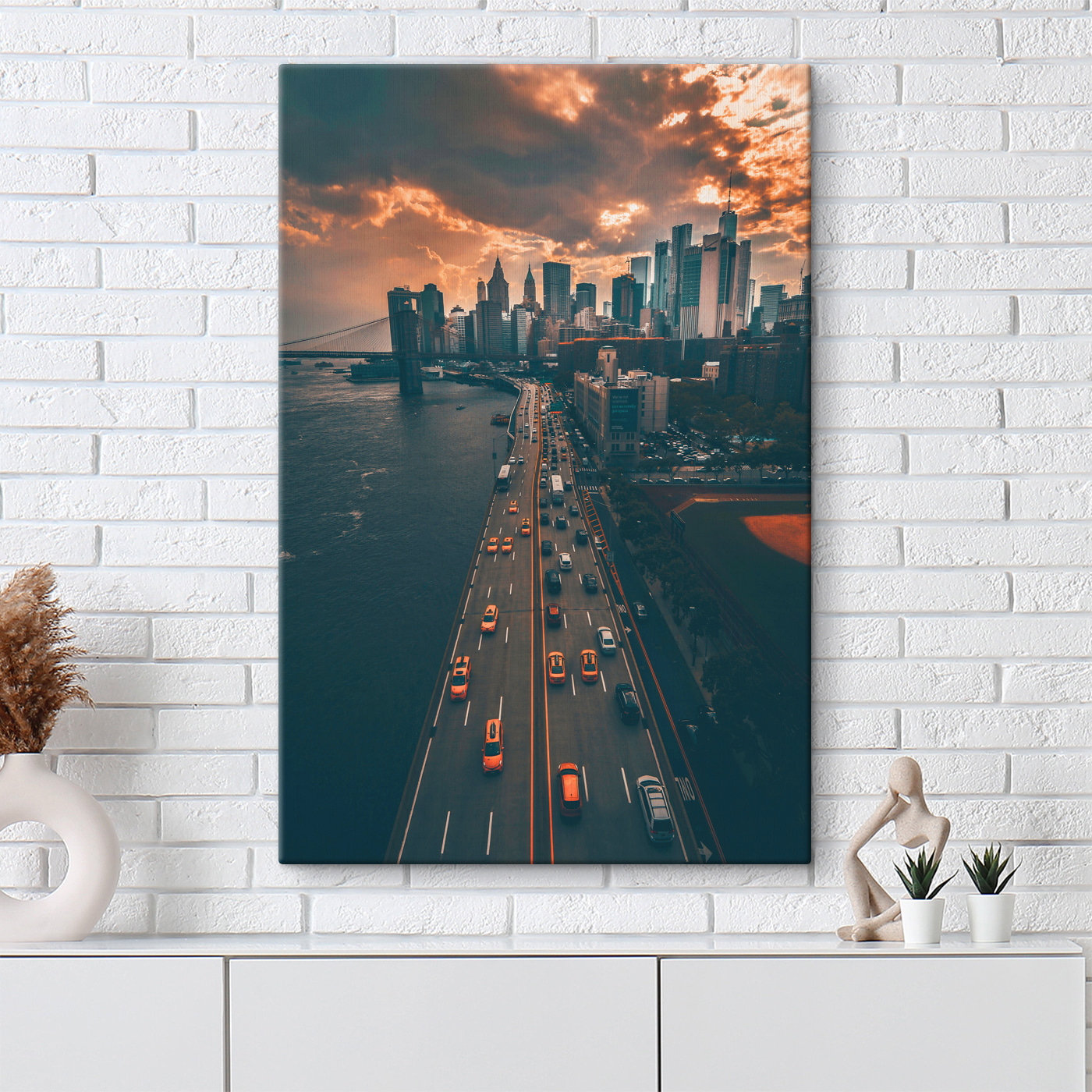 A bridge over water with cars and buildings in the background