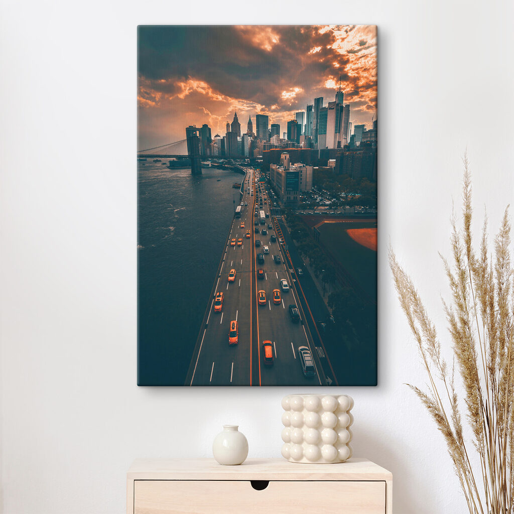 A bridge over water with cars and buildings in the background