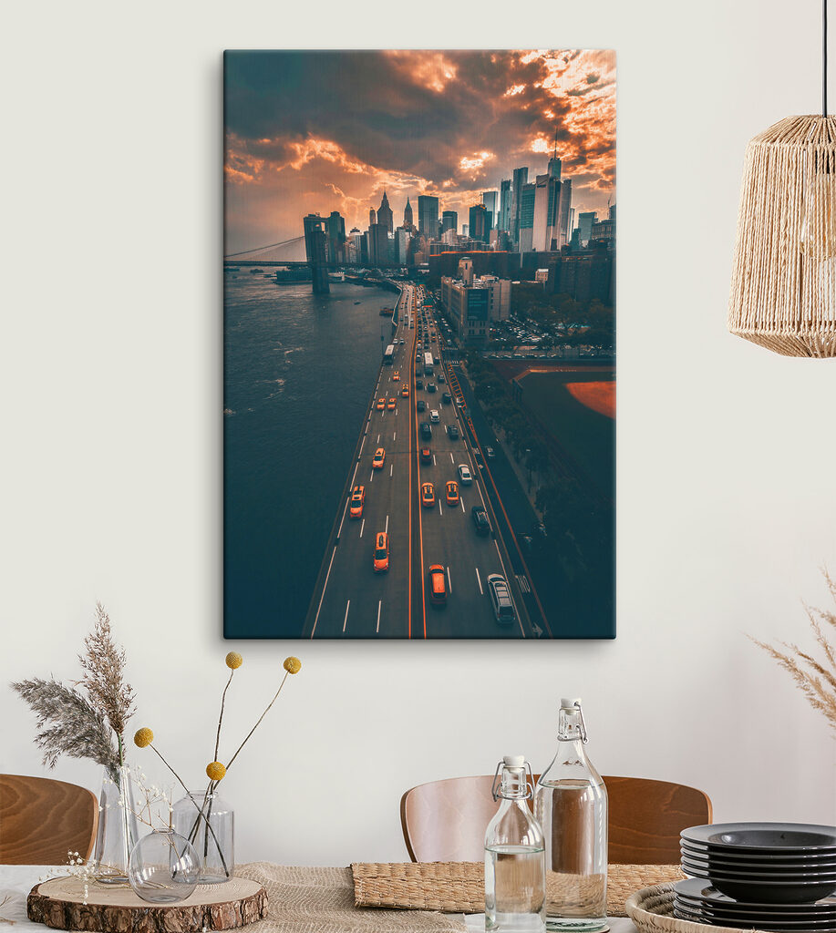 A bridge over water with cars and buildings in the background