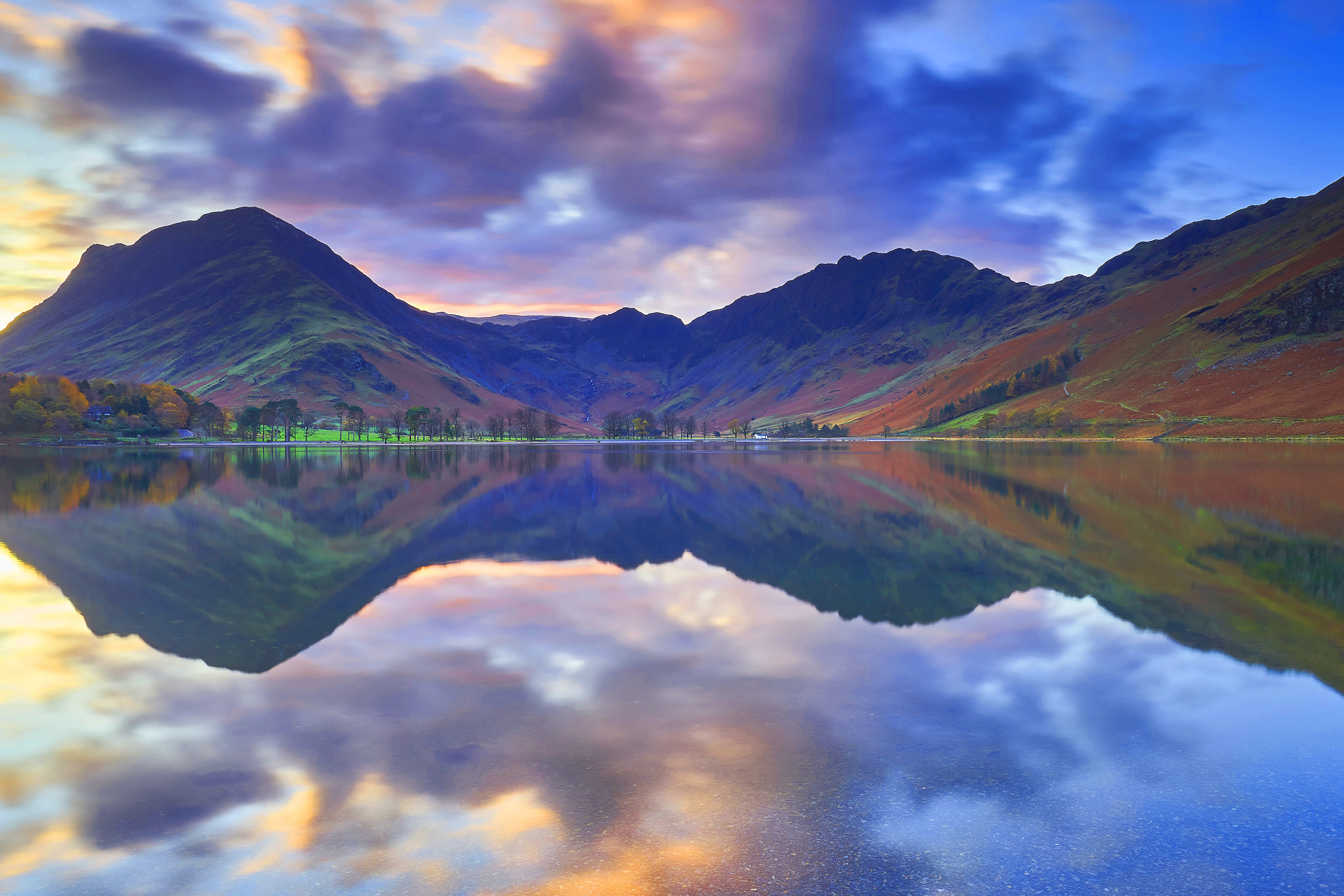 A lake with mountains in the background