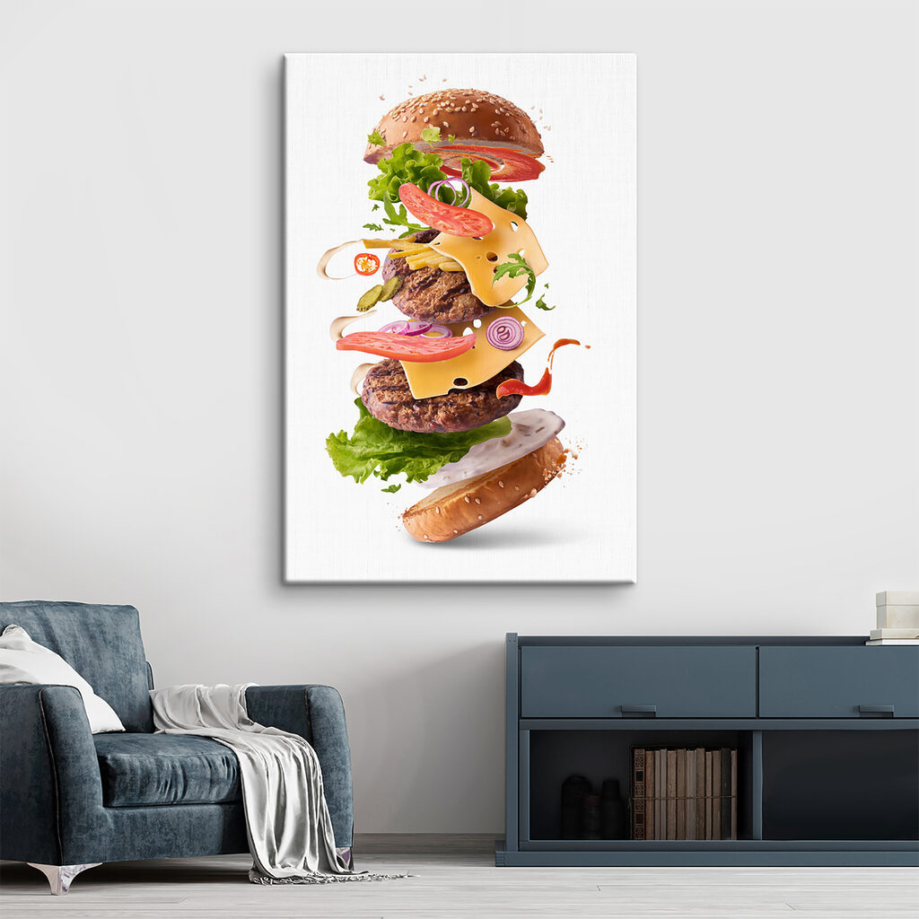 A hamburger with meat and vegetables flying in the air