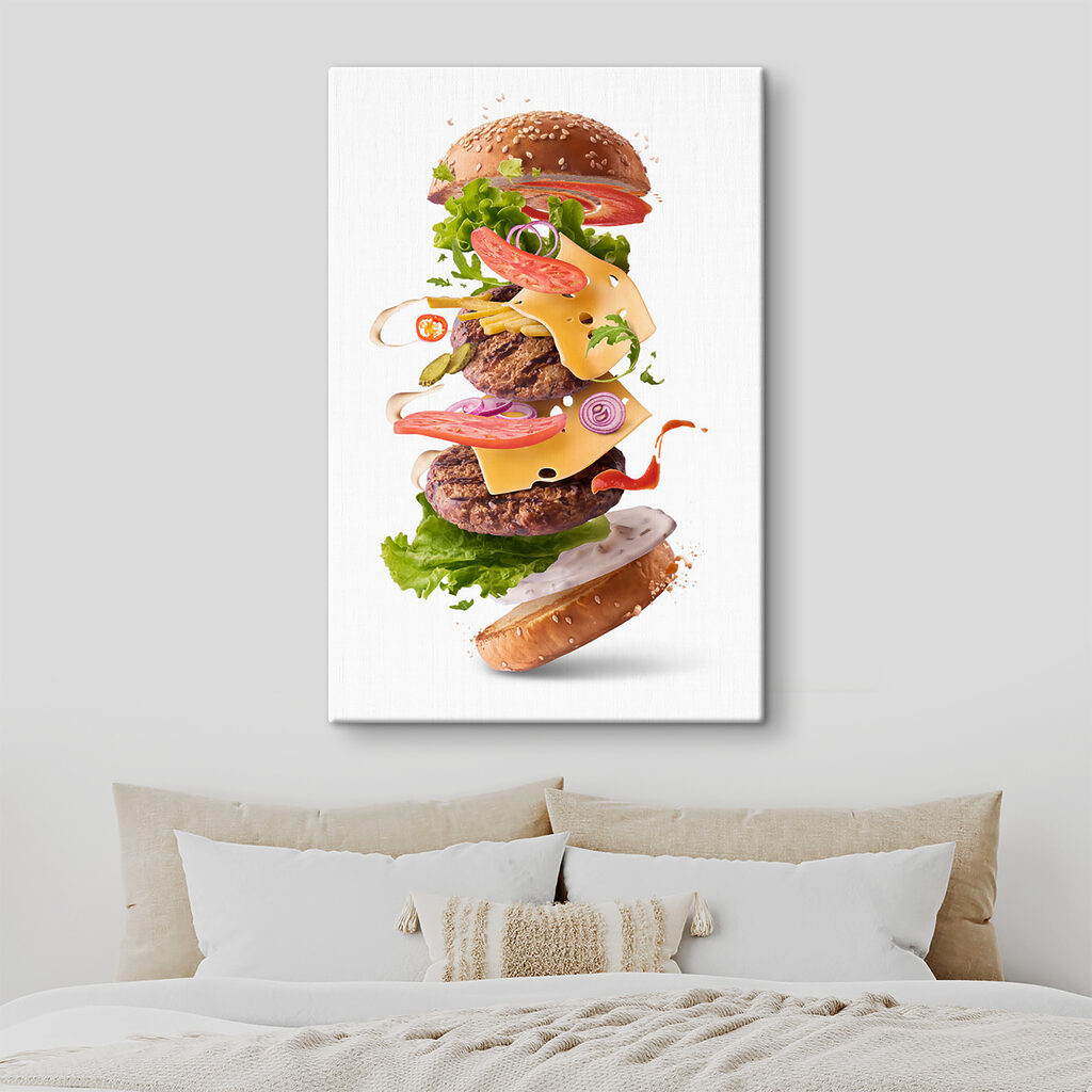 A hamburger with meat and vegetables flying in the air