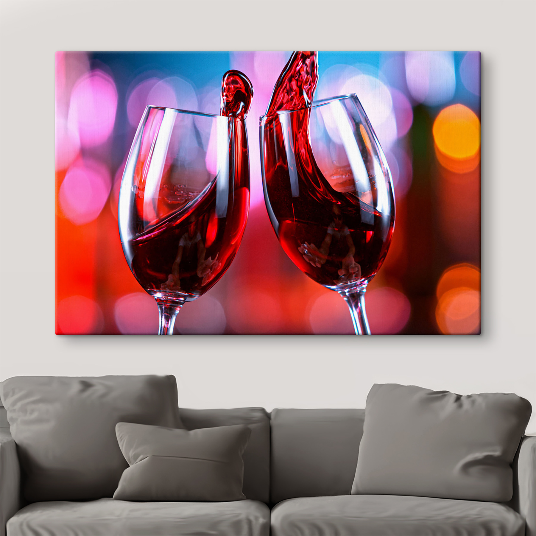 A couple of wine glasses with red liquid pouring into them