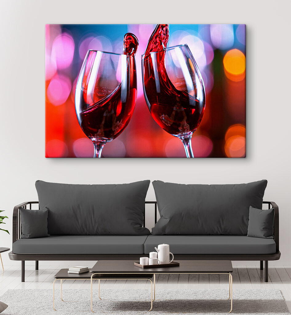 A couple of wine glasses with red liquid pouring into them