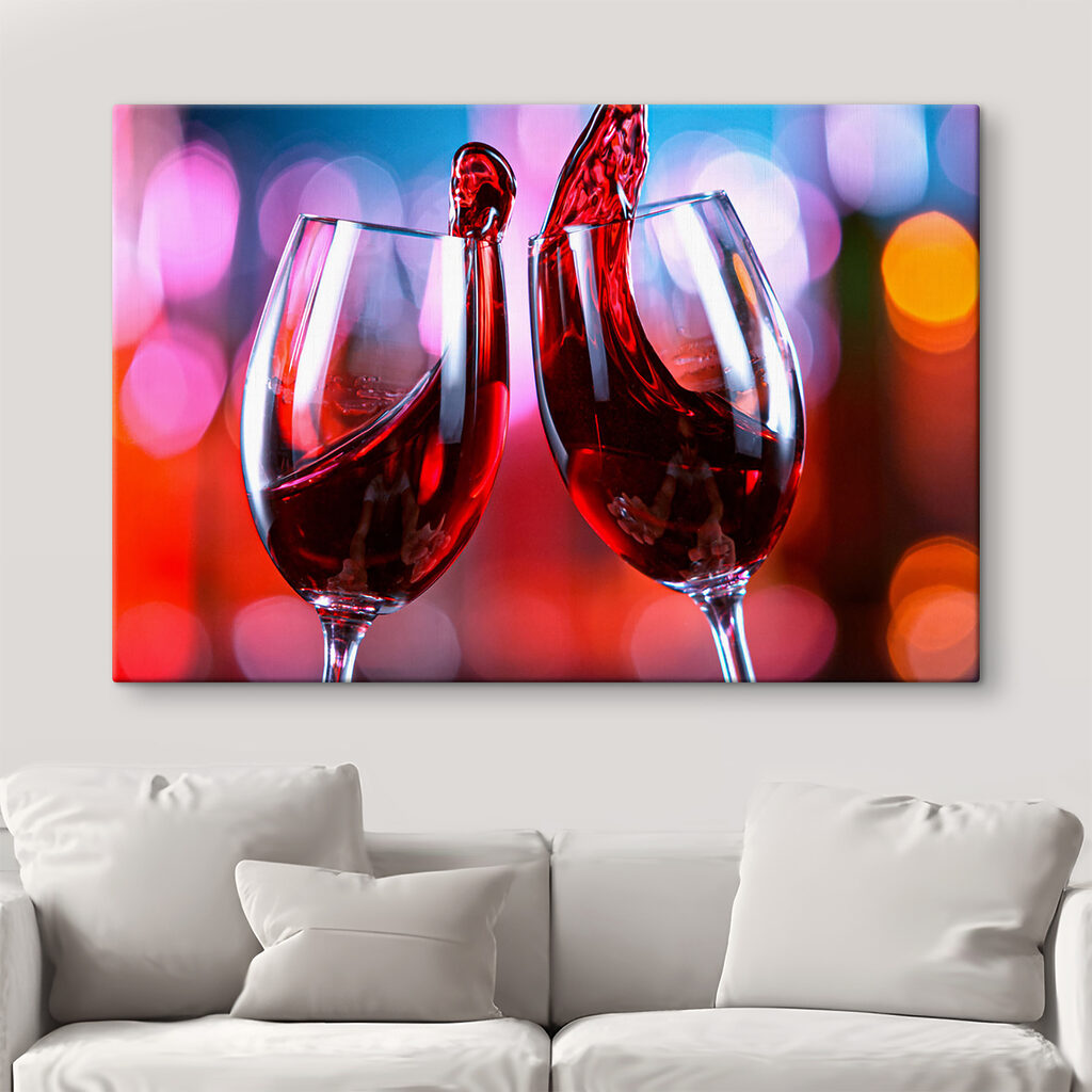 A couple of wine glasses with red liquid pouring into them
