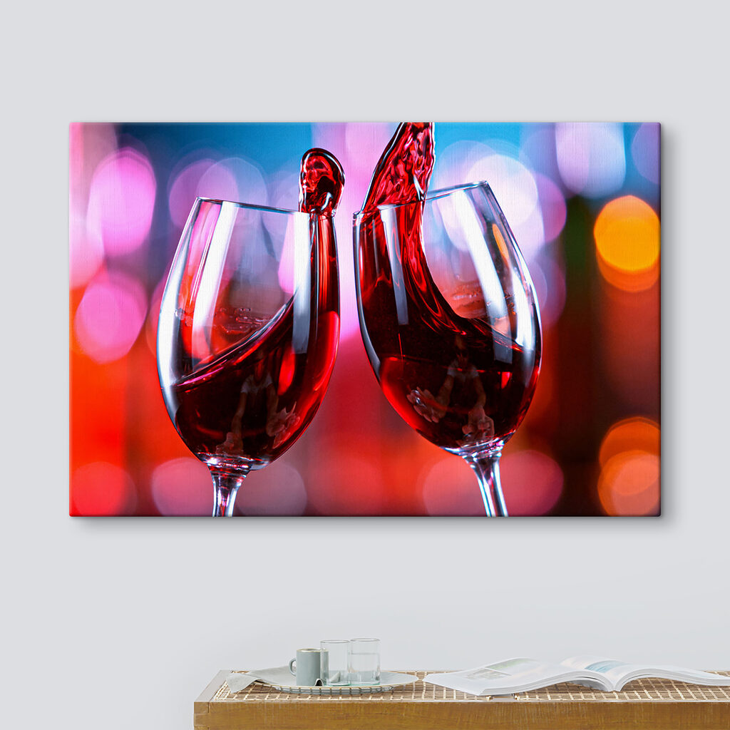 A couple of wine glasses with red liquid pouring into them