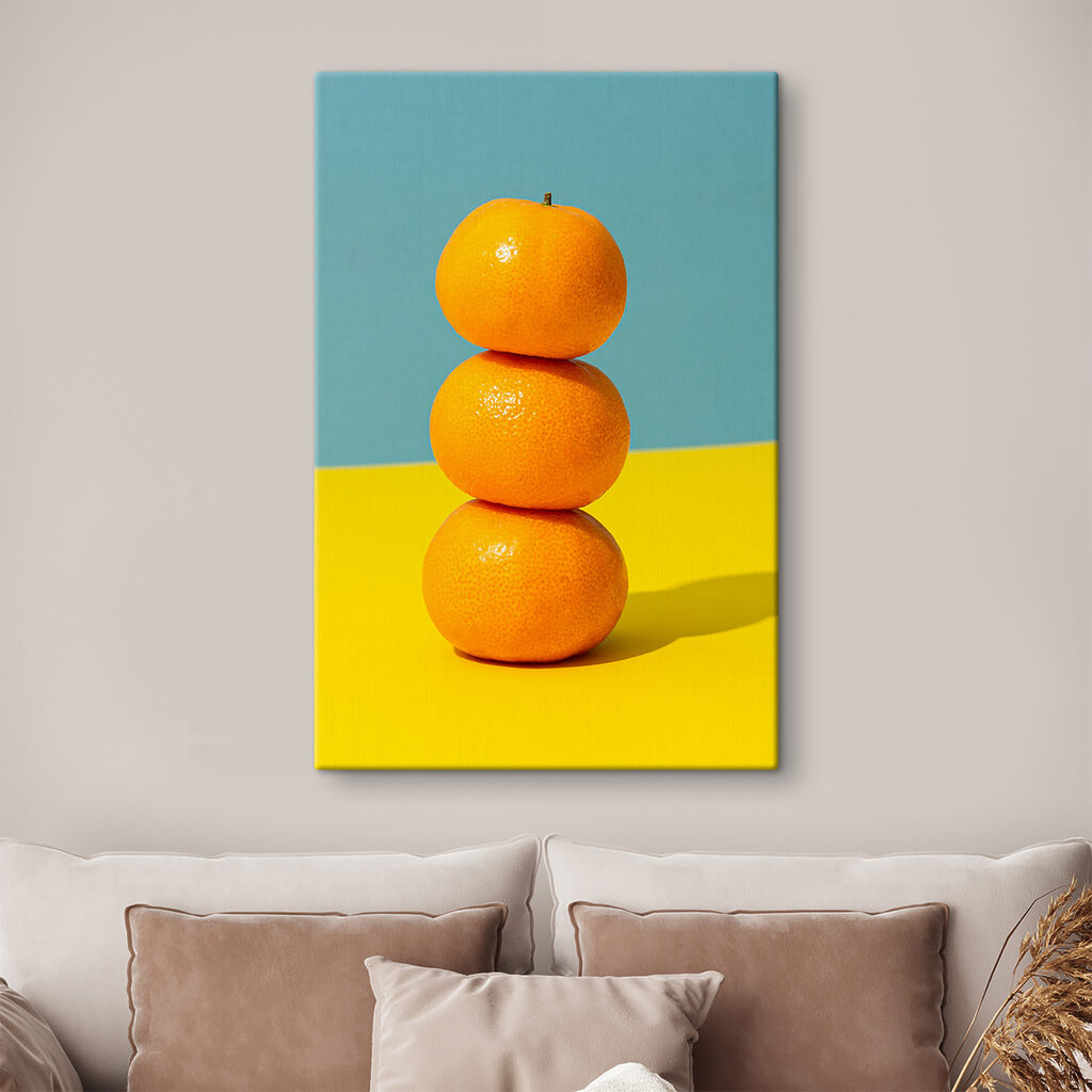 A stack of oranges on a yellow and blue surface