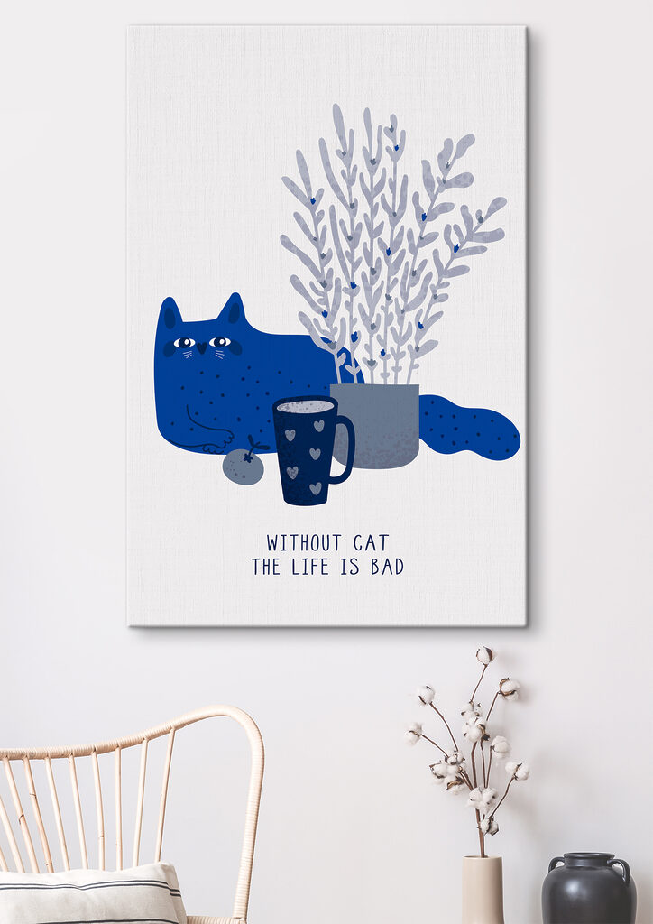 A cat sitting next to a cup and a plant
