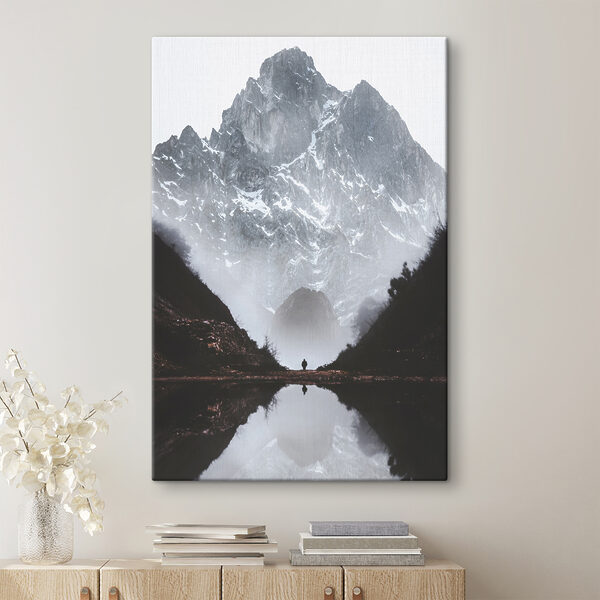 A person standing in a valley with a mountain in the background A person standing in a valley with a mountain in the background