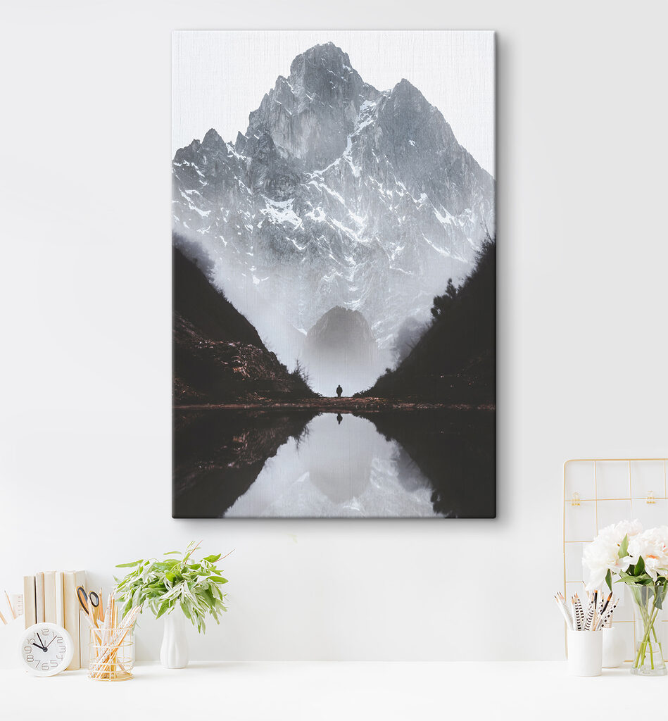 A person standing in a valley with a mountain in the background A person standing in a valley with a mountain in the background