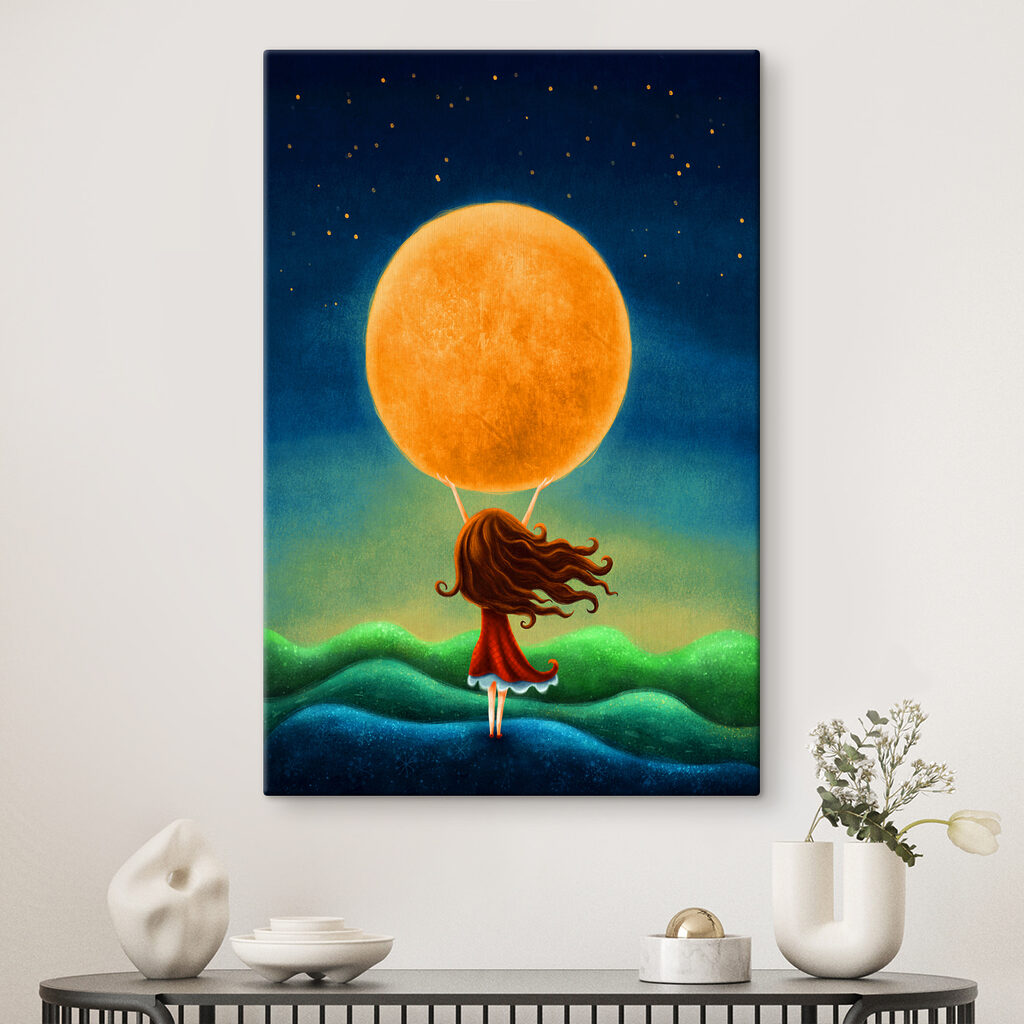A girl holding a large yellow moon A girl holding a large yellow moon
