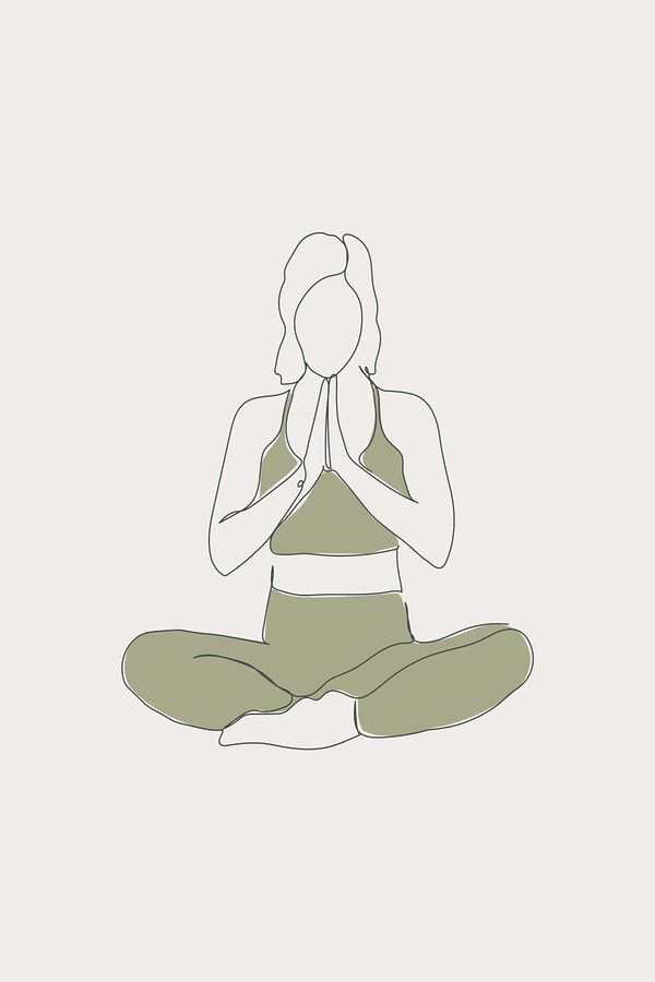 A woman sitting cross legged with her hands together