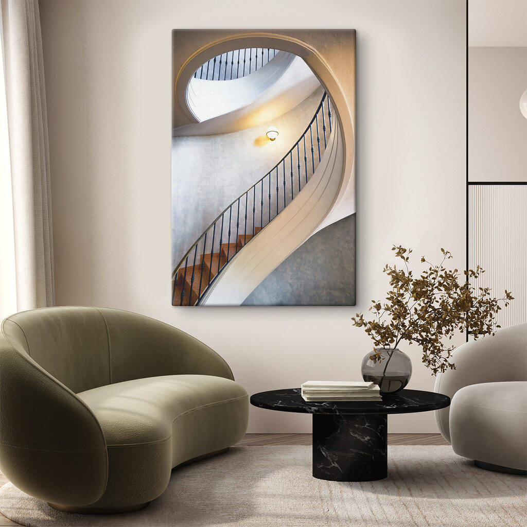 A spiral staircase with a black railing A spiral staircase with a black railing