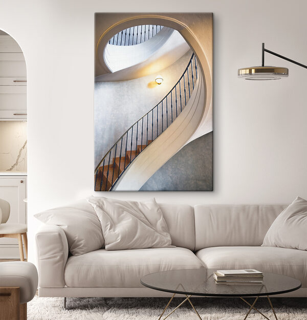 A spiral staircase with a black railing A spiral staircase with a black railing