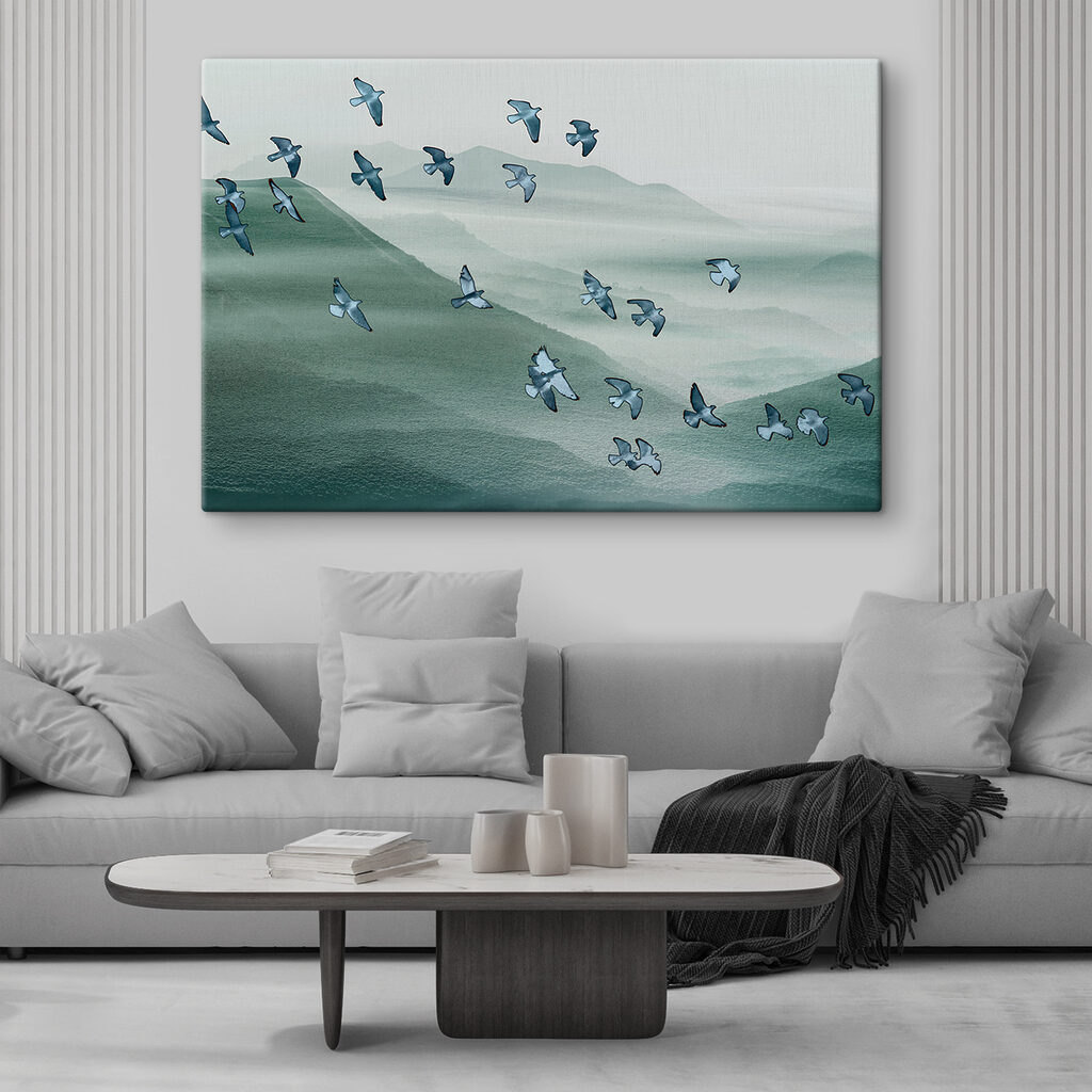 A flock of birds flying over a mountain
