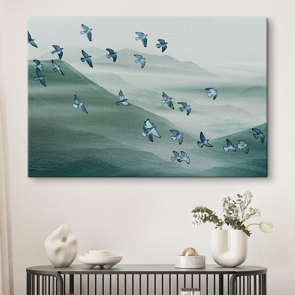 A flock of birds flying over a mountain