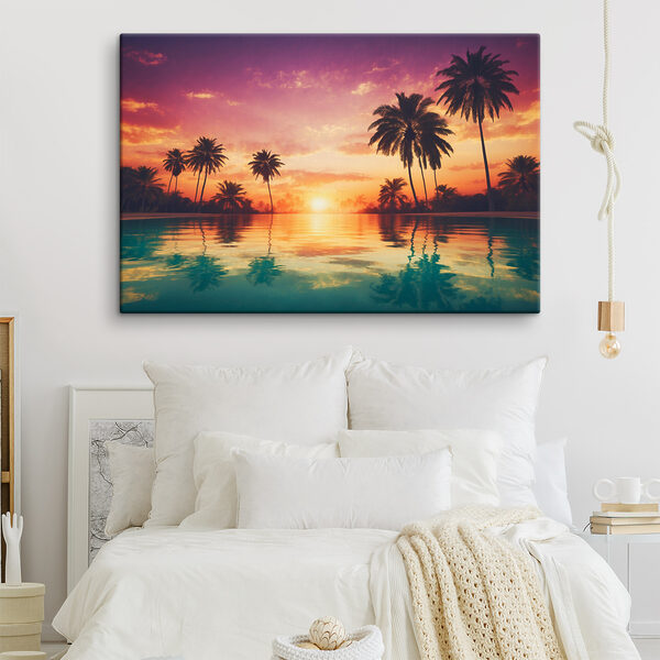 A sunset over a body of water with palm trees