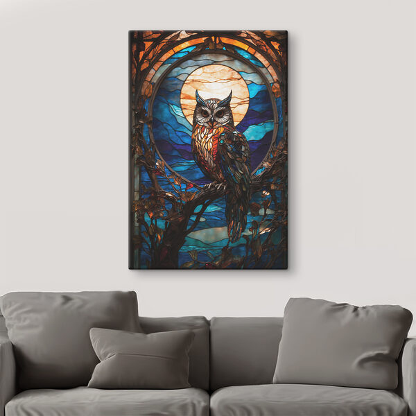 A stained glass owl on a tree branch A stained glass owl on a tree branch