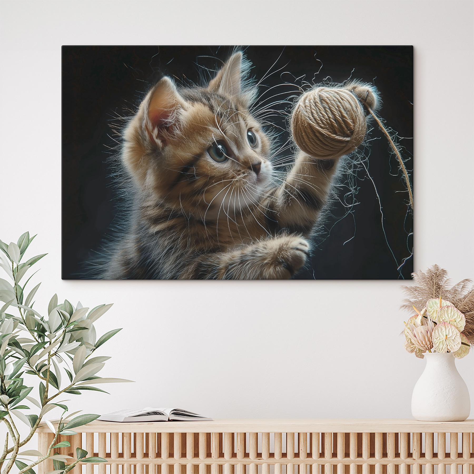 A cat playing with a ball of yarn