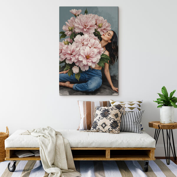 A woman sitting on a floor with a large bouquet of flowers