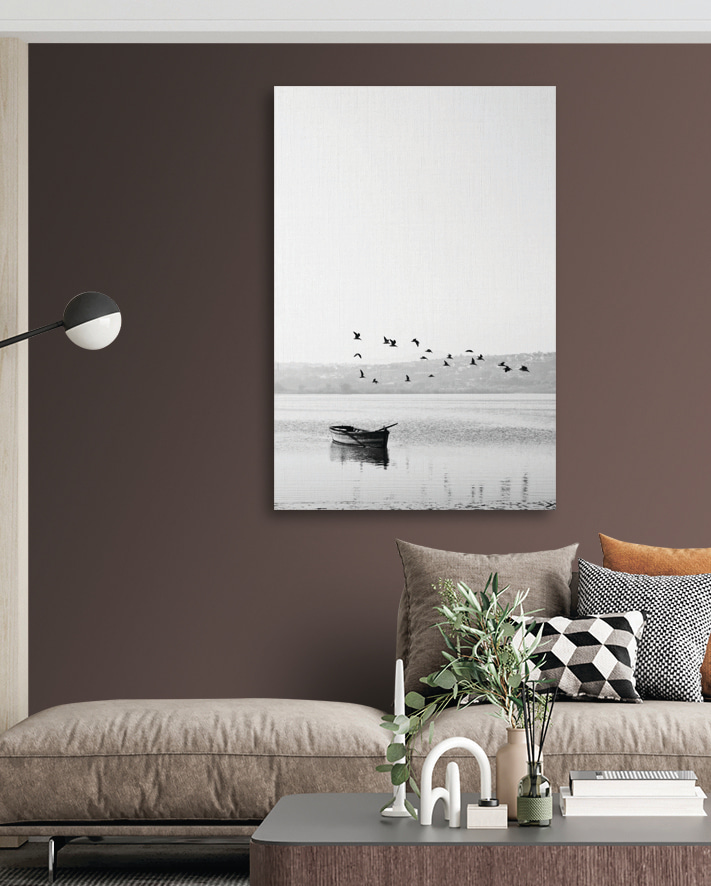 A group of birds flying over a body of water
