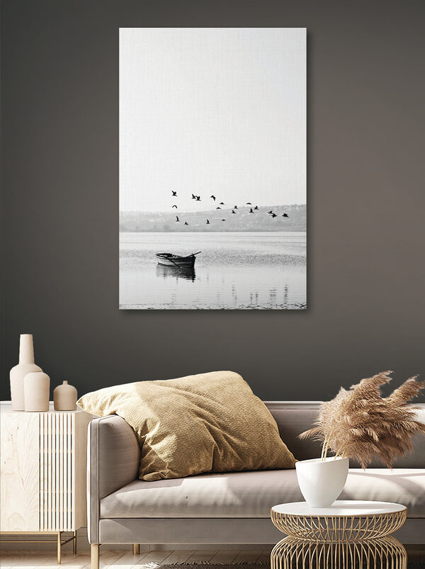 A group of birds flying over a body of water