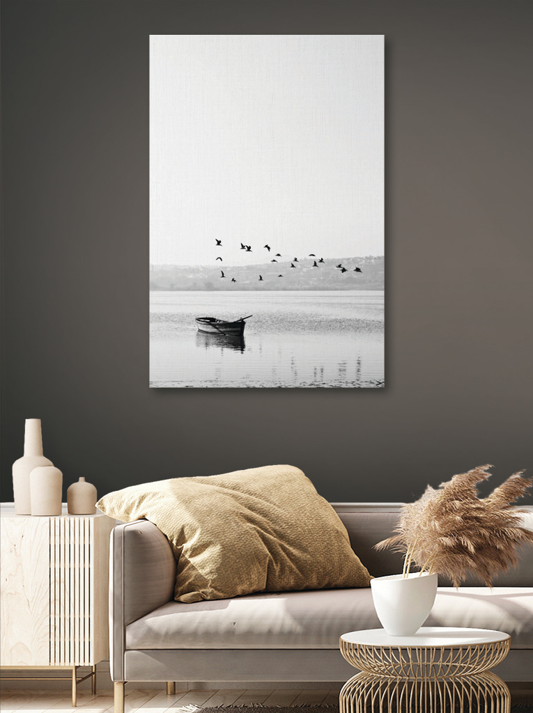 A group of birds flying over a body of water