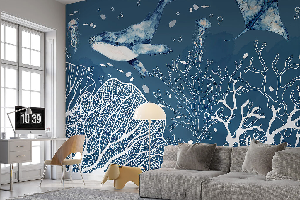 A whale and stingrays swimming in the ocean