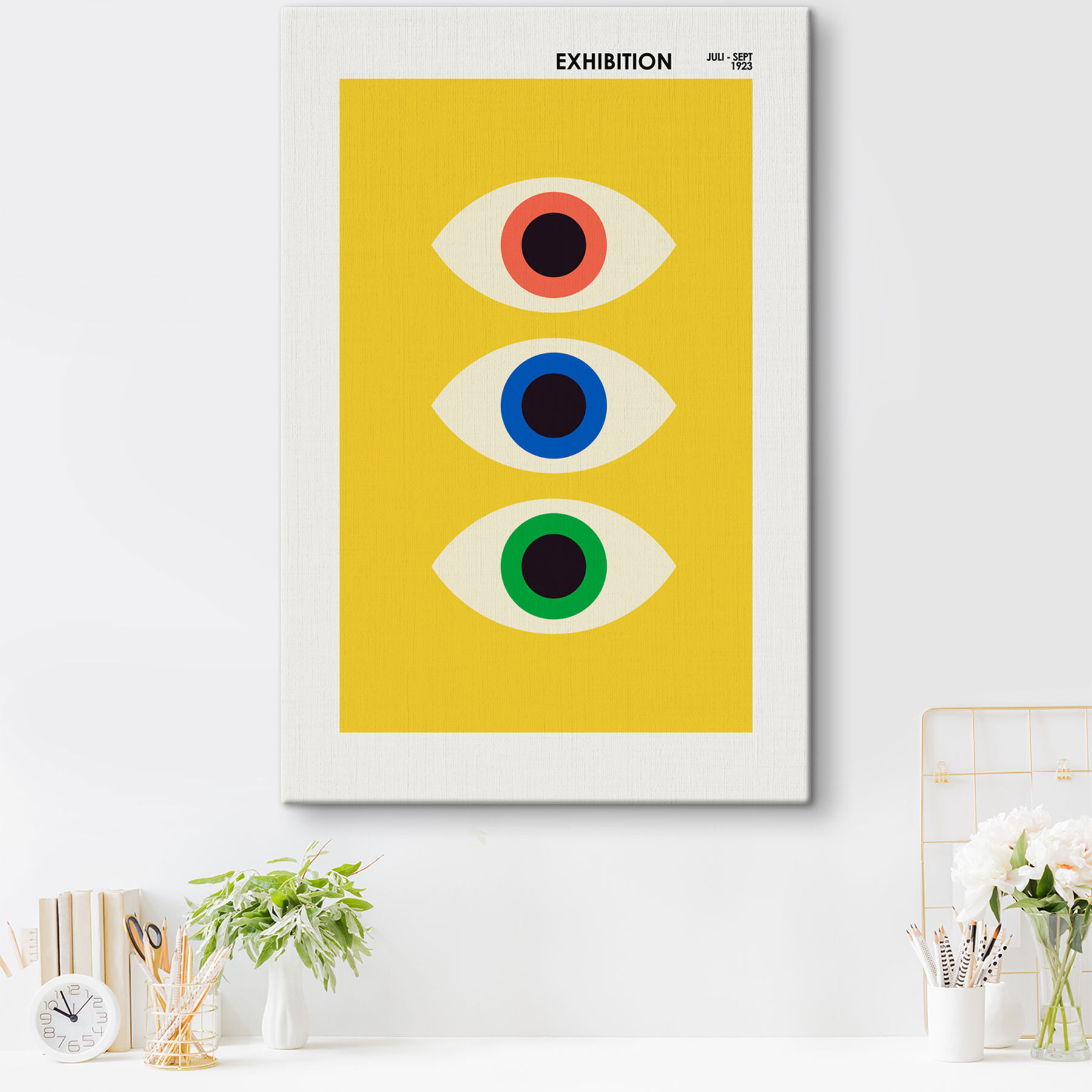 A yellow rectangular object with multi colored eyes A yellow rectangular object with multi colored eyes