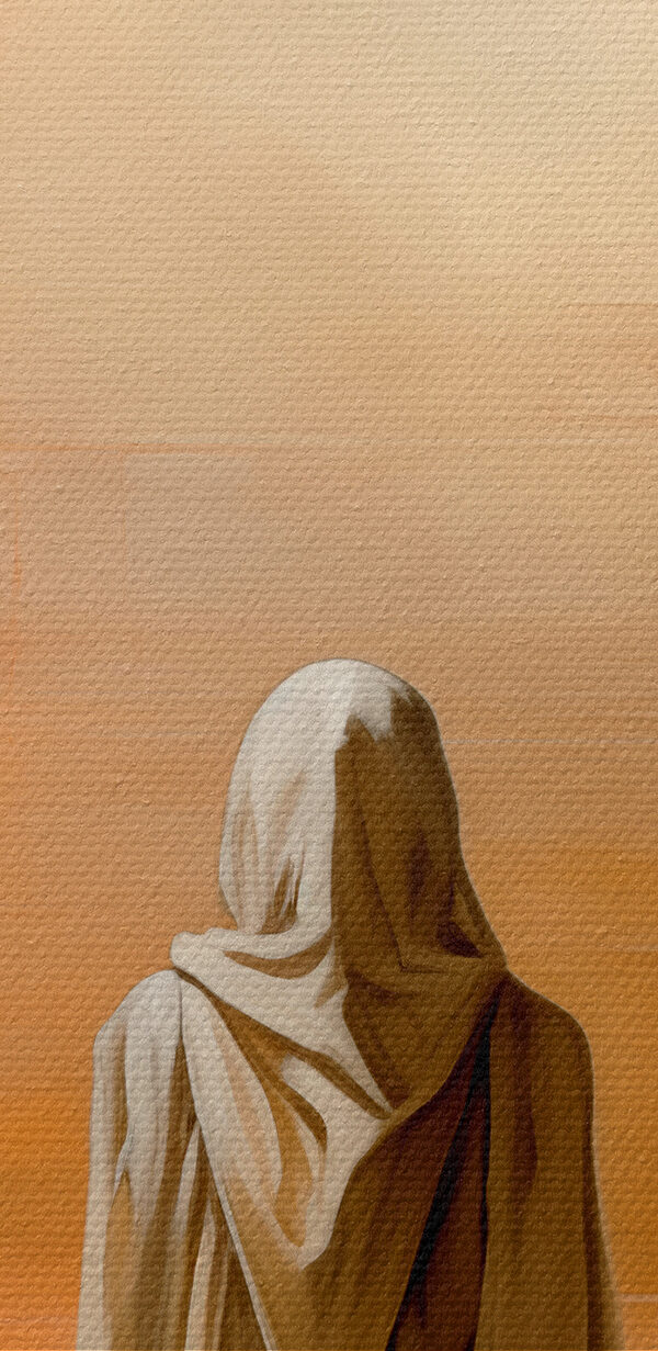 A person in a white robe standing in front of a pyramid