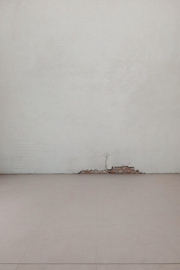 White wall with a crack in the wall White wall with a crack in the wall