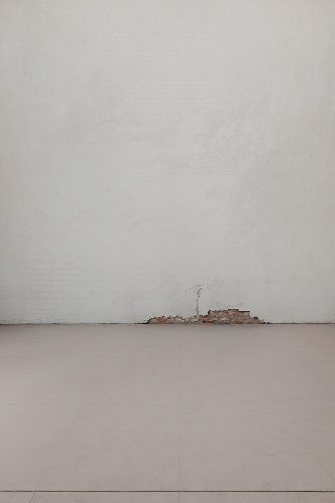 White wall with a crack in the wall White wall with a crack in the wall